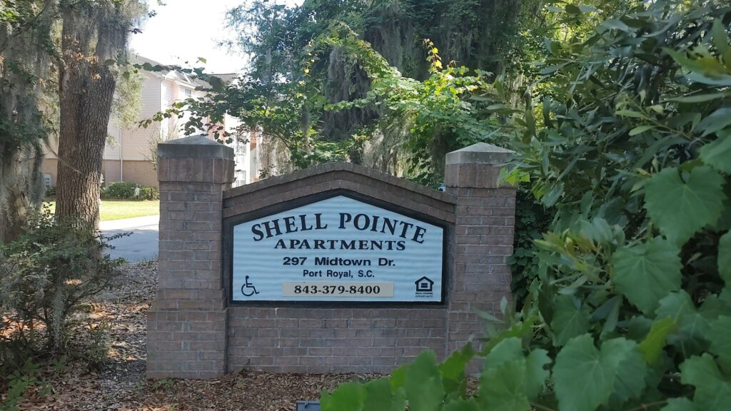 Brick Shell Pointe Apartments sign, which reads "SHELL POINTE APARTMENTS. 297 Midtown Dr. Port Royal, S.C. 843-379-8400"